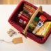 German shopping basket with packaged goods beside stacked euro coins and a price tag on a white surface.