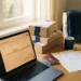 Small business desk with laptop showing marketplace dashboard, shipping boxes, Belgian passport, and business registration documents in morning light.